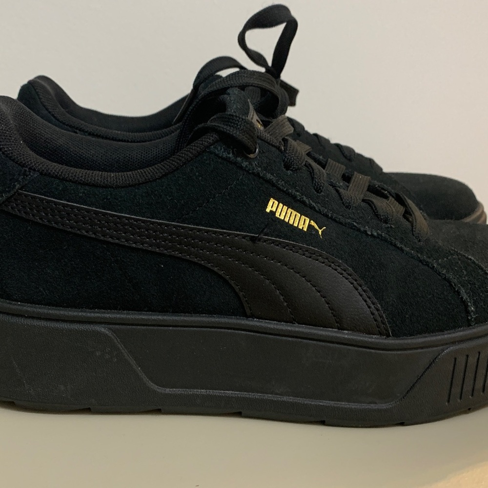 Puma size 8 Black Sneakers with Gold Accent